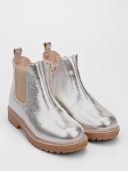 Silver leather Chelsea boots on brown sole on fur