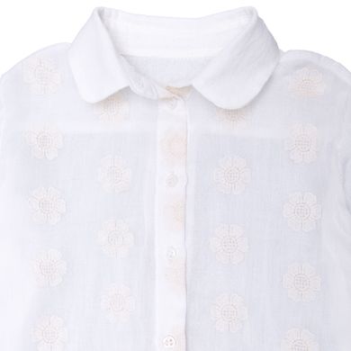 A milk-colored cotton blouse for a girl