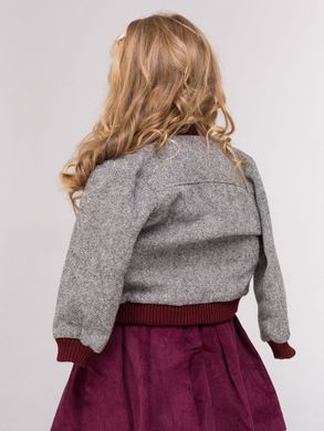 A tweed jacket with a burgundy cuff is universal