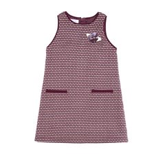 A burgundy sundress with a white pattern on the zipper with a flower for a girl