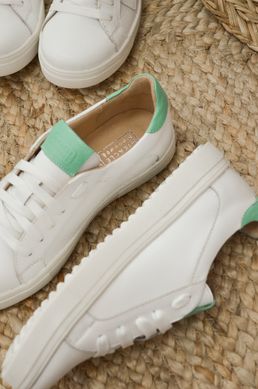 White leather sneakers with green inserts